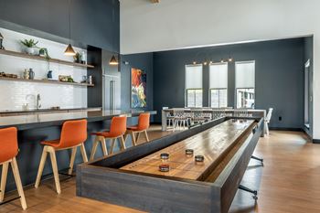 Resident social lounge with demonstration kitchen and shuffleboard table
